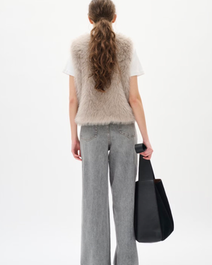 Faux fur vest features a regular fit, sleeveless cut, and round neckline. Perfect for layering, this piece offers a cozy feel and stylish silhouette for versatile outfits.